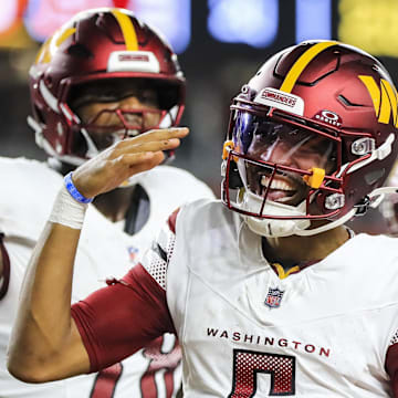 Washington Commanders quarterback Jayden Daniels reacts after scoring a touchdown against the Cincinnati Bengals. Mandatory Credit: Katie Stratman-Imagn Images