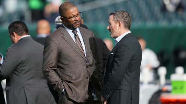 Dallas Cowboys VP of player personnel Will McClay (left) chats with Philadelphia Eagles general manager Howie Roseman.