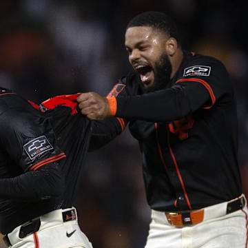 San Francisco, California, USA; San Francisco Giants designated hitter Wilmer Flores (left) and Heliot Ramos (right) celebrate their extra-inning win over the Athletics at Oracle Park.