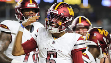 Sep 23, 2024; Cincinnati, Ohio, USA; Washington Commanders quarterback Jayden Daniels (5) reacts after scoring a touchdown against the Cincinnati Bengals in the first half at Paycor Stadium. Mandatory Credit: Katie Stratman-Imagn Images