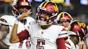Washington Commanders quarterback Jayden Daniels reacts after scoring a touchdown against the Cincinnati Bengals in the first half of Monday night's game at Paycor Stadium.