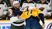 Jan 18, 2025; Nashville, Tennessee, USA;  Minnesota Wild right wing Ryan Hartman (38) and Nashville Predators center Mark Jankowski (17) exchange blows during the first period at Bridgestone Arena. Mandatory Credit: Steve Roberts-Imagn Images