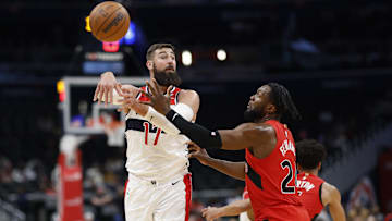 Oct 11, 2024; Washington, District of Columbia, USA; Washington Wizards center Jonas Valanciunas (17) passes the ball as Toronto Raptors guard Jamal Shead (23) defends in the second quarter at Capital One Arena. Mandatory Credit: Geoff Burke-Imagn Images