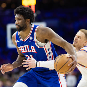 May 2, 2024; Philadelphia, Pennsylvania, USA; Philadelphia 76ers center Joel Embiid (21) drives against New York Knicks guard Donte DiVincenzo (0) during the second half of game six of the first round for the 2024 NBA playoffs at Wells Fargo Center. Mandatory Credit: Bill Streicher-USA TODAY Sports