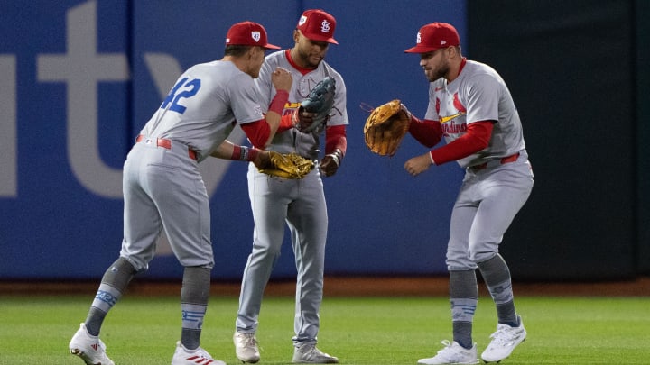 Apr 15, 2024; Oakland, California, USA;  (l to r) St. Louis Cardinals left fielder Lars Nootbaar (21), center fielder Victor Scott II (11) and right fielder Michael Siani (63) celebrate after defeating the Oakland Athletics at Oakland-Alameda County Coliseum. Mandatory Credit: Stan Szeto-USA TODAY Sports