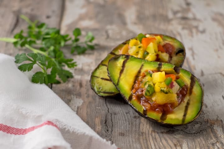 photo of a grilled avocado stuffed with salsa