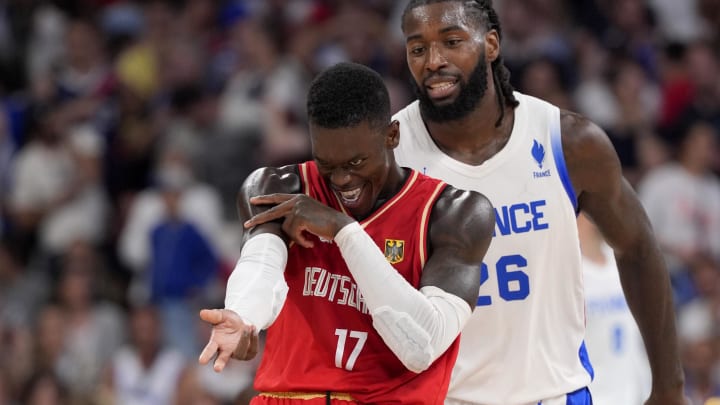 Aug 2, 2024; Villeneuve-d'Ascq, France; Germany point guard Dennis Schroder (17) celebrates after scoring as France centre Mathias Lessort (26) looks on in the second half in a men’s group B basketball game during the Paris 2024 Olympic Summer Games at Stade Pierre-Mauroy. Mandatory Credit: John David Mercer-USA TODAY Sports