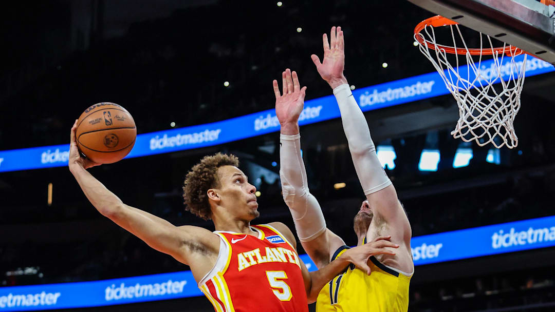 Jan 26, 2026; Atlanta, Georgia, USA; Atlanta Hawks guard Dyson Daniels (5) dunks the ball against Indiana Pacers center Micah Potter (11) during the first quarter at State Farm Arena. Mandatory Credit: Jordan Godfree-Imagn Images
