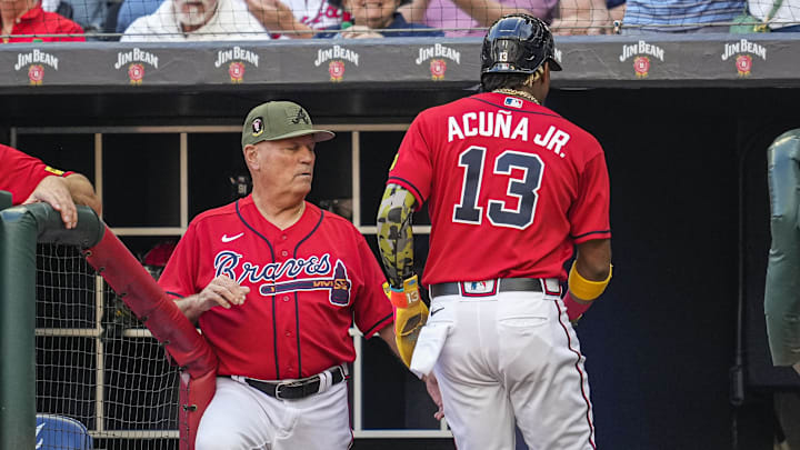 Acuna Jr. reacts with Snitker in the dugout. Acuna Jr. reacts with Snitker in the dugout.