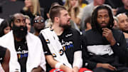 Nov 22, 2024; Inglewood, California, USA;  Los Angeles Clippers guard James Harden (1, left) and center Ivica Zubac (40, center) and Kawhi Leonard (right) watch a game from the bench during the second half against the Sacramento Kings at Intuit Dome. Mandatory Credit: Kiyoshi Mio-Imagn Images