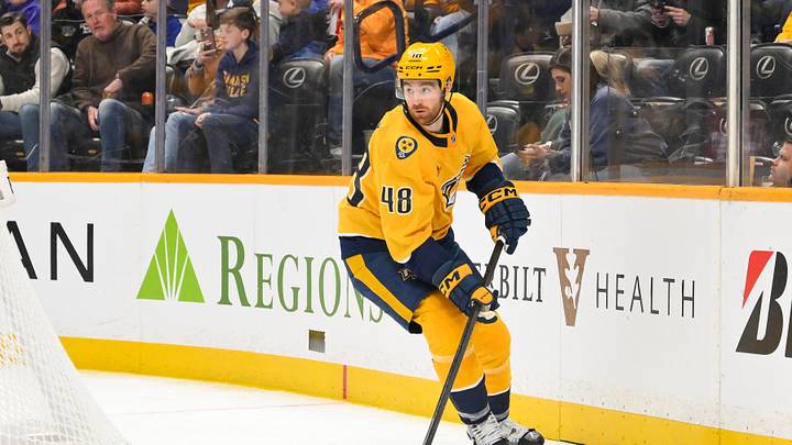 Nov 29, 2025; Nashville, Tennessee, USA;  Nashville Predators defenseman Nick Perbix (48) plays the puck behind the net against the Winnipeg Jets during the second period at Bridgestone Arena. Mandatory Credit: Steve Roberts-Imagn Images