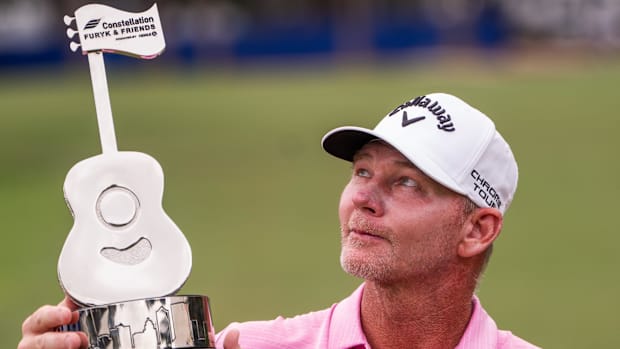 Tommy Gainey looks at the trophy after winning the Constellation Furyk & Friends PGA Tour Champions event.
