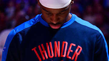 Jan 8, 2025; Cleveland, Ohio, USA; Oklahoma City Thunder guard Shai Gilgeous-Alexander (2) listens to the national anthem before the game between the Cleveland Cavaliers and the Thunder at Rocket Mortgage FieldHouse. Mandatory Credit: Ken Blaze-Imagn Images