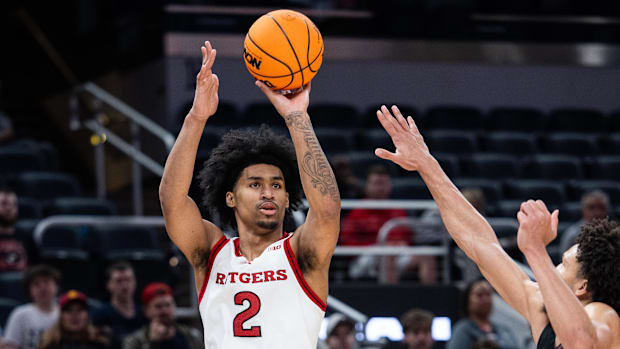 Rutgers Scarlet Knights guard Dylan Harper (2) shoots the ball while USC Trojans guard Desmond Claude (1) defends