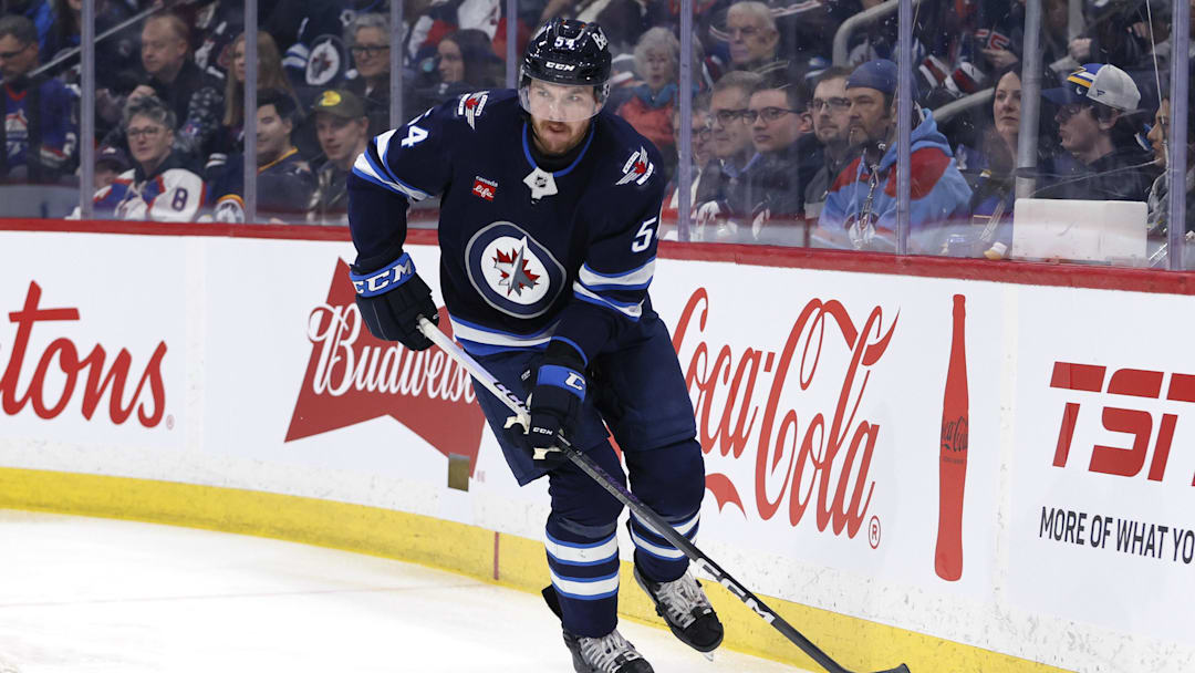 Apr 7, 2025; Winnipeg, Manitoba, CAN; Winnipeg Jets defenseman Dylan Samberg (54) skates up the ice against the St. Louis Blues in the first period at Canada Life Centre. Mandatory Credit: James Carey Lauder-Imagn Images