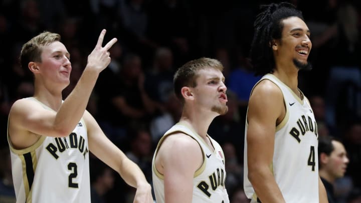 Purdue guards Fletcher Loyer (2),Braden Smith (3) and forward Trey Kaufman-Renn (4) react to the dunk 