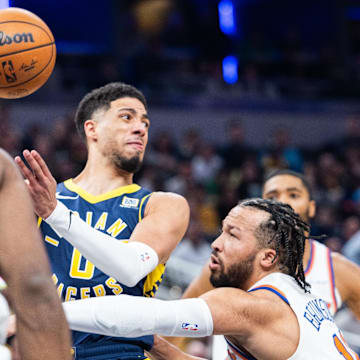 Feb 11, 2025; Indianapolis, Indiana, USA: Indiana Pacers guard Tyrese Haliburton (0) passes the ball while New York Knicks guard Jalen Brunson (11) defends in the first half at Gainbridge Fieldhouse. Mandatory Credit: Trevor Ruszkowski-Imagn Images