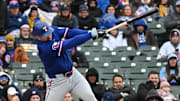 Apr 9, 2025; Chicago, Illinois, USA; Texas Rangers first baseman Jake Burger (21) hits a single during the fourth inning against the Chicago Cubs at Wrigley Field. 