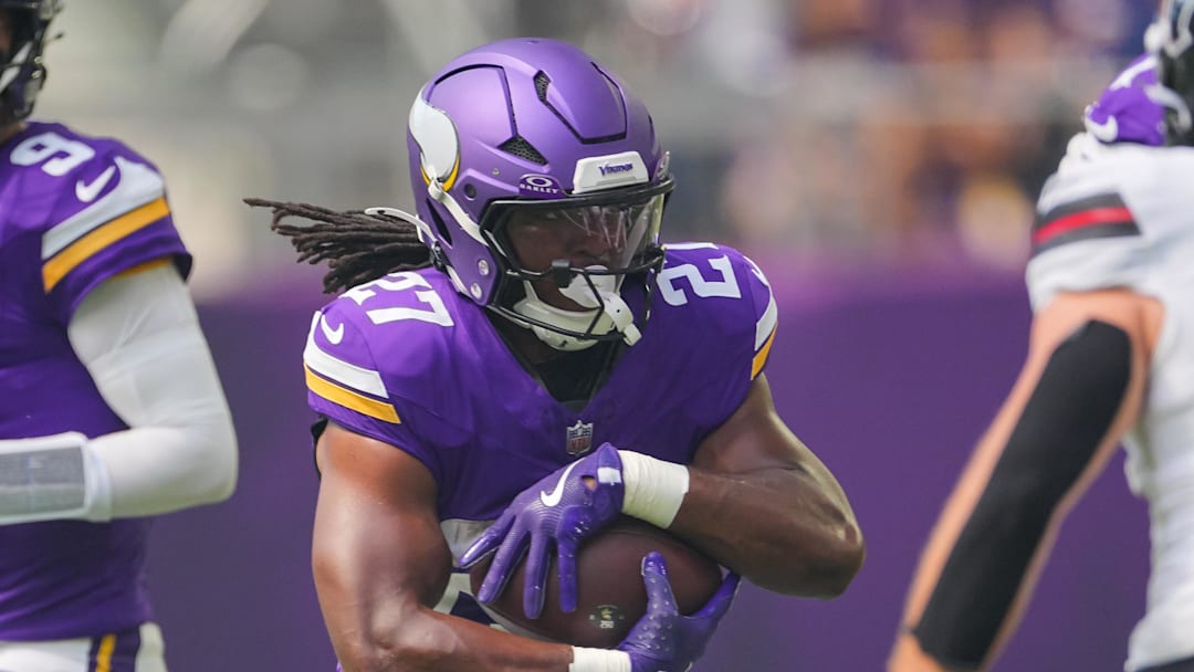 Aug 9, 2025; Minneapolis, Minnesota, USA; Minnesota Vikings running back Jordan Mason (27) runs with the ball against the Houston Texans in the first quarter at U.S. Bank Stadium.