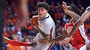 Feb 2, 2025; Champaign, Illinois, USA; Illinois Fighting Illini forward Will Riley (7) drives the ball between Ohio State Buckeyes guard Bruce Thornton (2) and others players during the first half at State Farm Center. Mandatory Credit: Ron Johnson-Imagn Images
