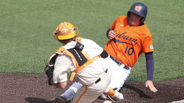 Tennessee's Cannon Peebles (5) tags out Auburn's Lucas Steele (10) at home plate during game 3 of their NCAA baseball game series on May 4, 2025, in Knoxville, Tenn.
