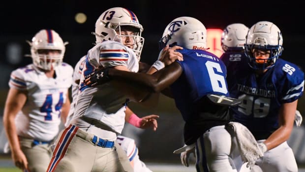 Vestavia Hills quarterback John Paul Head is tackled by Tuscaloosa County linebacker Kevin Riley (6) at Tuscaloosa County Hig