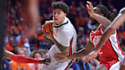 Feb 2, 2025; Champaign, Illinois, USA; Illinois Fighting Illini forward Will Riley (7) drives the ball between Ohio State Buckeyes guard Bruce Thornton (2) and others players during the first half at State Farm Center. Mandatory Credit: Ron Johnson-Imagn Images