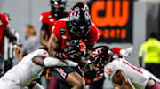 Sep 27, 2025; Raleigh, North Carolina, USA; North Carolina State Wolfpack wide receiver Terrell Anderson (9) is tackled by Virginia Tech Hokies cornerback Isaiah Brown-Murray (9), and linebacker Noah Chambers (16) during the first half of the game against Virginia Tech Hokies at Carter-Finley Stadium. Mandatory Credit: Jaylynn Nash-Imagn Images