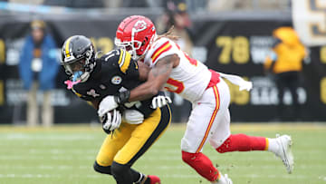 Dec 25, 2024; Pittsburgh, Pennsylvania, USA;  Pittsburgh Steelers wide receiver George Pickens (14) runs after a catch as Kansas City Chiefs safety Justin Reid (20) defends during the second quarter at Acrisure Stadium. Mandatory Credit: Charles LeClaire-Imagn Images