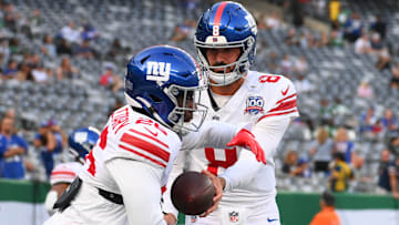 Aug 24, 2024; East Rutherford, New Jersey, USA; New York Giants quarterback Daniel Jones (8) hands the ball off to running back Devin Singletary (26) before the game against the New York Jets at MetLife Stadium.  