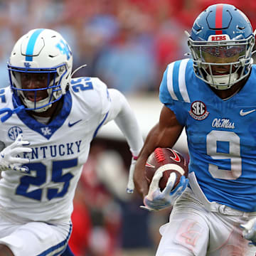 Sep 28, 2024; Oxford, Mississippi, USA; Mississippi Rebels wide receiver Tre Harris (9) runs after a catch for a first down as Kentucky Wildcats defensive back Jordan Lovett (25) pursues during the second half at Vaught-Hemingway Stadium. Mandatory Credit: Petre Thomas-Imagn Images