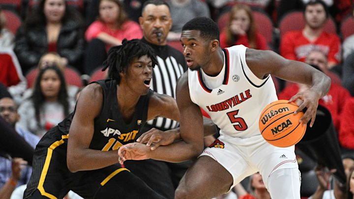 Nov 15, 2022; Louisville, Kentucky, USA;  Louisville Cardinals forward Brandon Huntley-Hatfield (5) dribbles against Appalachian State Mountaineers forward CJ Huntley (15) during the first half at KFC Yum! Center. Appalachian State defeated Louisville 61-60. Mandatory Credit: Jamie Rhodes-Imagn Images