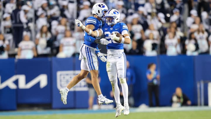 Oct 21, 2023; Provo, Utah, USA; Brigham Young Cougars cornerback Evan Johnson (36) and safety Ethan Slade (26) celebrate after an interception against the Texas Tech Red Raiders in the second half at LaVell Edwards Stadium. 