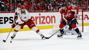 May 15, 2025; Washington, District of Columbia, USA; Carolina Hurricanes left wing William Carrier (28) passes the puck as Washington Capitals defenseman Trevor van Riemsdyk (57) defends in the second period in game five of the second round of the 2025 Stanley Cup Playoffs at Capital One Arena. Mandatory Credit: Geoff Burke-Imagn Images