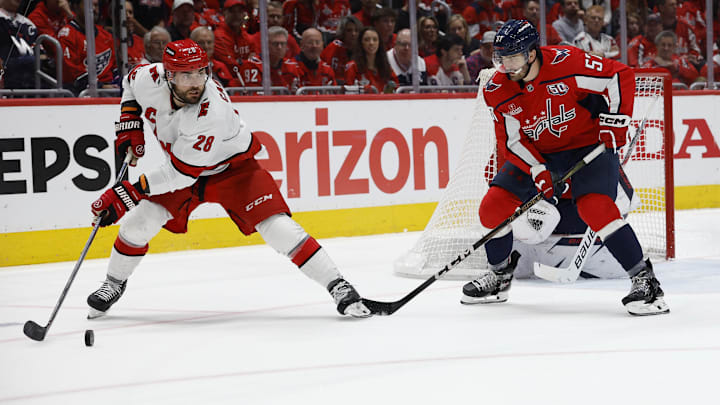 May 15, 2025; Washington, District of Columbia, USA; Carolina Hurricanes left wing William Carrier (28) passes the puck as Washington Capitals defenseman Trevor van Riemsdyk (57) defends in the second period in game five of the second round of the 2025 Stanley Cup Playoffs at Capital One Arena. Mandatory Credit: Geoff Burke-Imagn Images