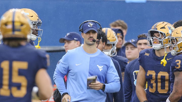 Sep 27, 2025; Morgantown, West Virginia, USA; West Virginia Mountaineers defensive coordinator Zac Alley talks to his players during the first quarter against the Utah Utes at Milan Puskar Stadium. Mandatory Credit: Ben Queen-Imagn Images