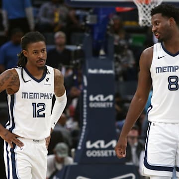 Nov 5, 2025; Memphis, Tennessee, USA; Memphis Grizzlies forward/center Jaren Jackson Jr. (8) talks with guard Ja Morant (12) during the second quarter against the Houston Rockets at FedExForum. Mandatory Credit: Petre Thomas-Imagn Images