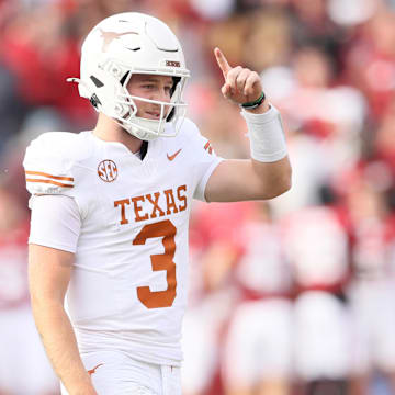 Nov 16, 2024; Fayetteville, Arkansas, USA; Texas Longhorns quarterback Quinn Ewers (3) celebrates after making a final first down to end the game against the Arkansas Razorbacks at Donald W. Reynolds Razorback Stadium. Texas won 20-10. Mandatory Credit: Nelson Chenault-Imagn Images