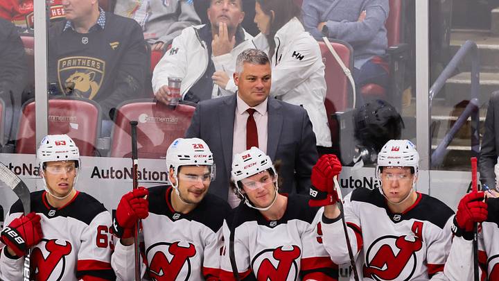 Nov 14, 2024; Sunrise, Florida, USA; New Jersey Devils head coach Sheldon Keefe watches from the bench against the Florida Panthers during the third period at Amerant Bank Arena. Mandatory Credit: Sam Navarro-Imagn Images