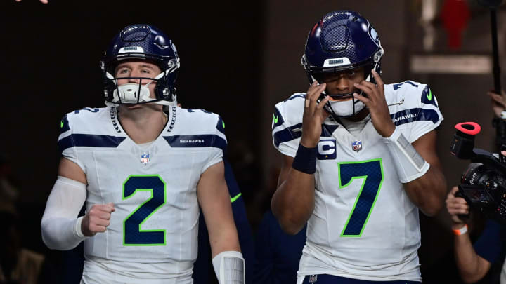 Jan 7, 2024; Glendale, Arizona, USA; Seattle Seahawks quarterback Geno Smith (7) and quarterback Drew Lock (2) take the field for warmups prior to the game against the Arizona Cardinals at State Farm Stadium. Mandatory Credit: Matt Kartozian-USA TODAY Sports