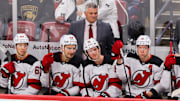 Nov 14, 2024; Sunrise, Florida, USA; New Jersey Devils head coach Sheldon Keefe watches from the bench against the Florida Panthers during the third period at Amerant Bank Arena. Mandatory Credit: Sam Navarro-Imagn Images