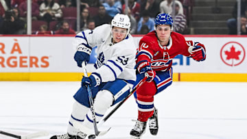 Sep 30, 2023; Montreal, Quebec, CAN; Toronto Maple Leafs right wing Easton Cowan (53) plays the puck against Montreal Canadiens left wing Juraj Slafkovsky (20) during the first period at Bell Centre. Mandatory Credit: David Kirouac-Imagn Images