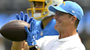 Sep 8, 2024; Los Angeles Chargers head coach Jim Harbaugh catches the ball for quarterback Justin Herbert (10) 