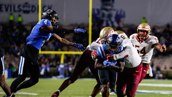 Oct 18, 2024; Durham, North Carolina, USA; Duke Blue Devils quarterback Maalik Murphy (6) attempts to run the ball to the end zone but is tackled by Florida State Seminoles defensive lineman Darrell Jackson Jr. (6) during the first half of the game at Wallace Wade Stadium. Mandatory Credit: Jaylynn Nash-Imagn Images