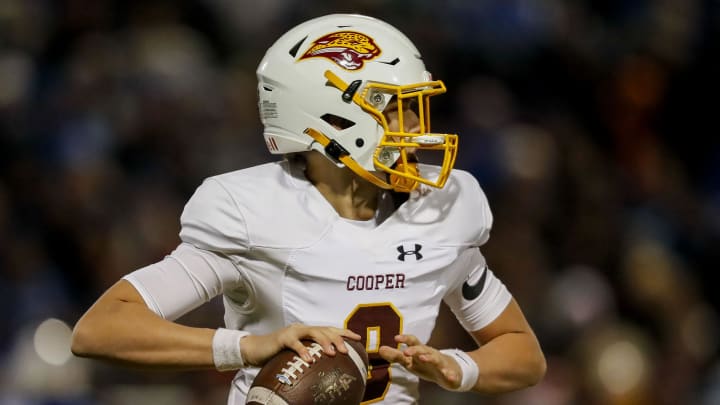 Cooper quarterback Cam O'Hara (8) throws a pass against Highlands in the first half at Highlands High School Nov. 24, 2023.