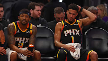 Apr 9, 2025; Phoenix, Arizona, USA; Phoenix Suns guard Bradley Beal (3) and guard Devin Booker (1) react on the bench against the Oklahoma City Thunder during the second half at Footprint Center. Mandatory Credit: Mark J. Rebilas-Imagn Images