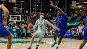 Jan 30, 2025; New Orleans, Louisiana, USA; Tulane Green Wave guard Rowan Brumbaugh (7) drives to the basket against Memphis Tigers forward Dain Dainja (42) during the second half at Avron B. Fogelman Arena in Devlin Fieldhouse.