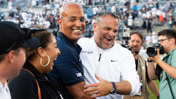 Penn State Athletic Director Pat Kraft, right, laughs with head coach James Franklin