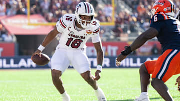 Dec 31, 2024; Orlando, FL, USA; South Carolina Gamecocks quarterback LaNorris Sellers (16) runs the ball against Illinois Fighting Illini linebacker Joe Barna (43) in the first quarter at Camping World Stadium. Mandatory Credit: Jeremy Reper-Imagn Images