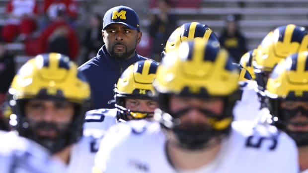 Michigan Wolverines head coach Sherrone Moore on the sideline prior to a college football game in the Big Ten.